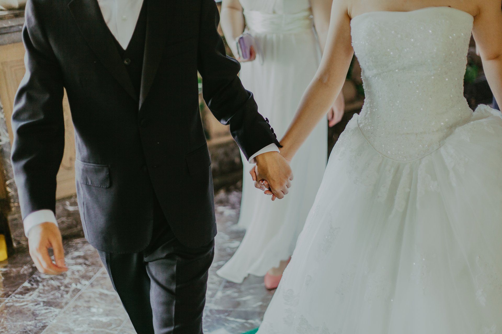 Bride and groom holding hands representing relationship, infidelity, or marital investigation services